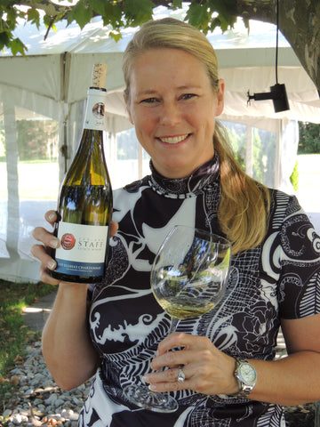 Winemaker Sue-Ann Staff with a bottle of 2019 Elisha's Chardonnay