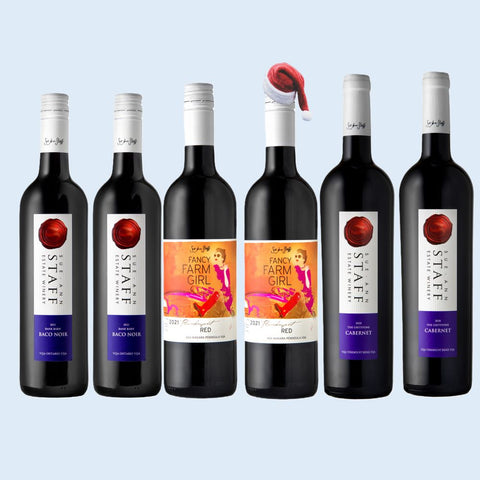 Set of wine bottles with various labels on a light blue background