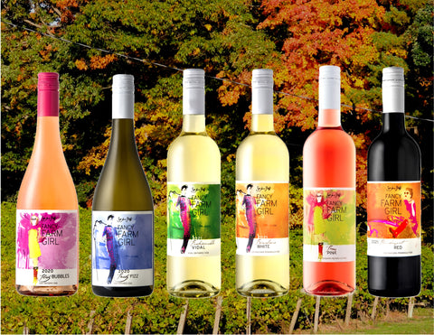 Collage image of six bottles of Fancy Farm Girl wine superimposed on a photograph of the vineyard in fall.