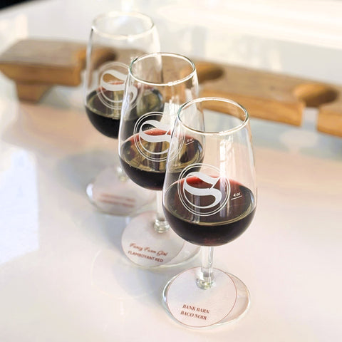 Photo of three wine tasting glasses in a row, each with 2 oz of red wine. 