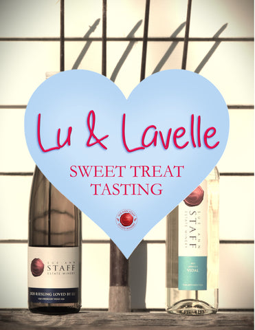Two wine bottles on a wooden surface with a heart-shaped logo and text 'Lu & Lavelle Sweet Treat Tasting' in the foreground.