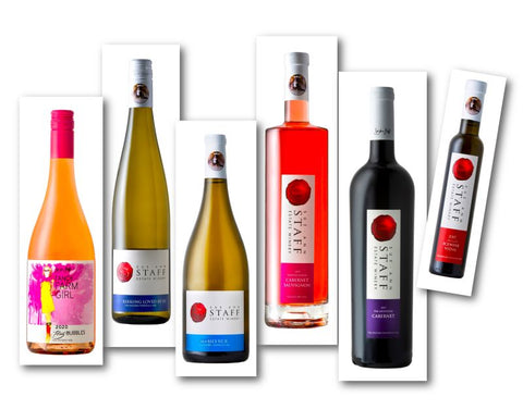 Photo of six wine bottles included in our Just Add Turkey Thanksgiving Pack. Flirty Bubbles, Riesling Loved By Lu, Mabel's VCR, Windsock Rosé Cabernet Sauvignon, Gritstone Cabernet and Howard's Icewine Vidal 
