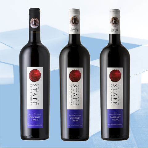 Three bottles of Sue Anne Estate Winery Cabernet Franc wine on a light blue background
