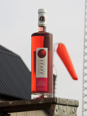 a bottle of The Windsock Cabernet Sauvignon Rosé with its namesake windsock behind